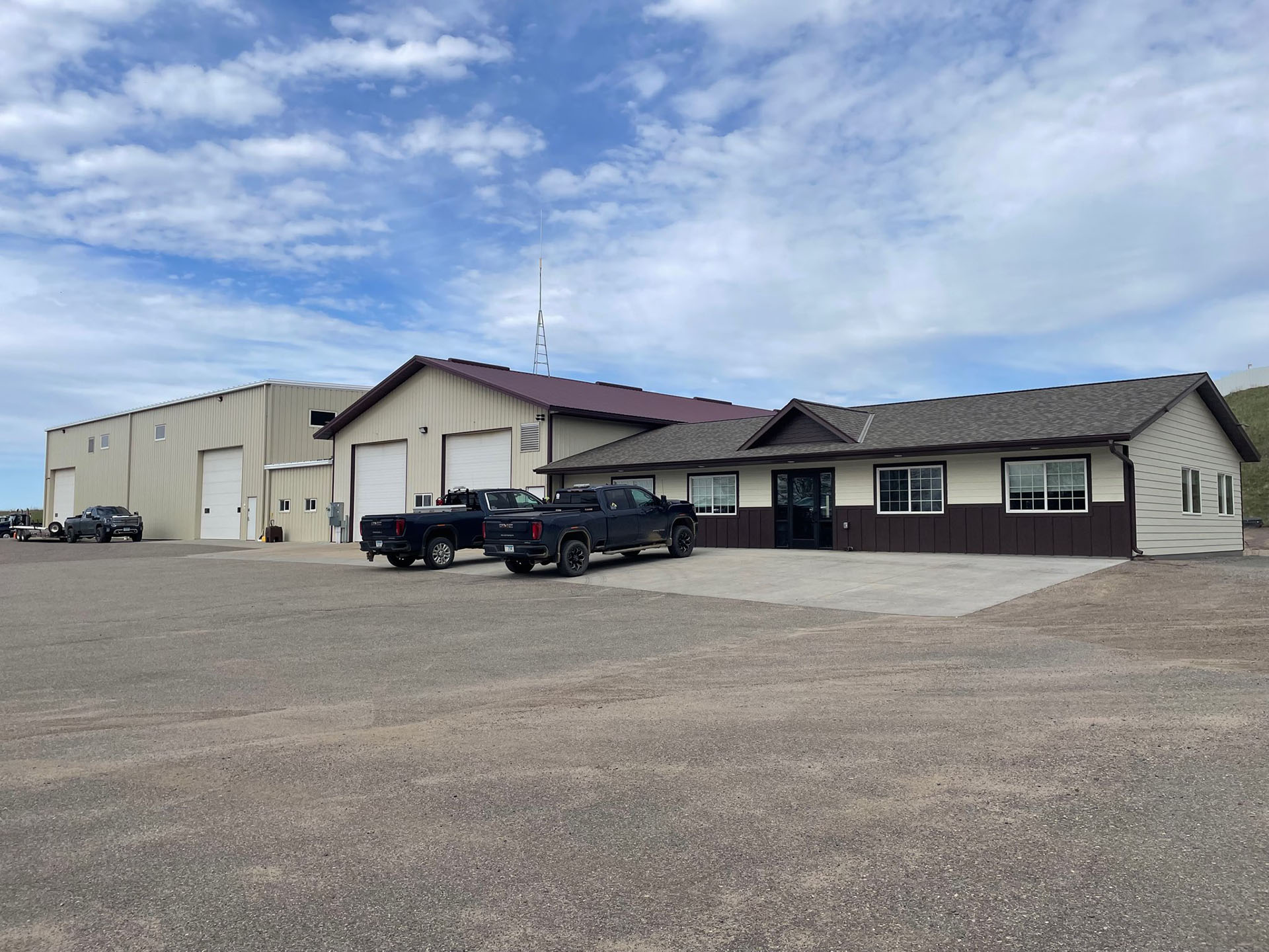 Large CAT excavator providing road maintenance in a residential area