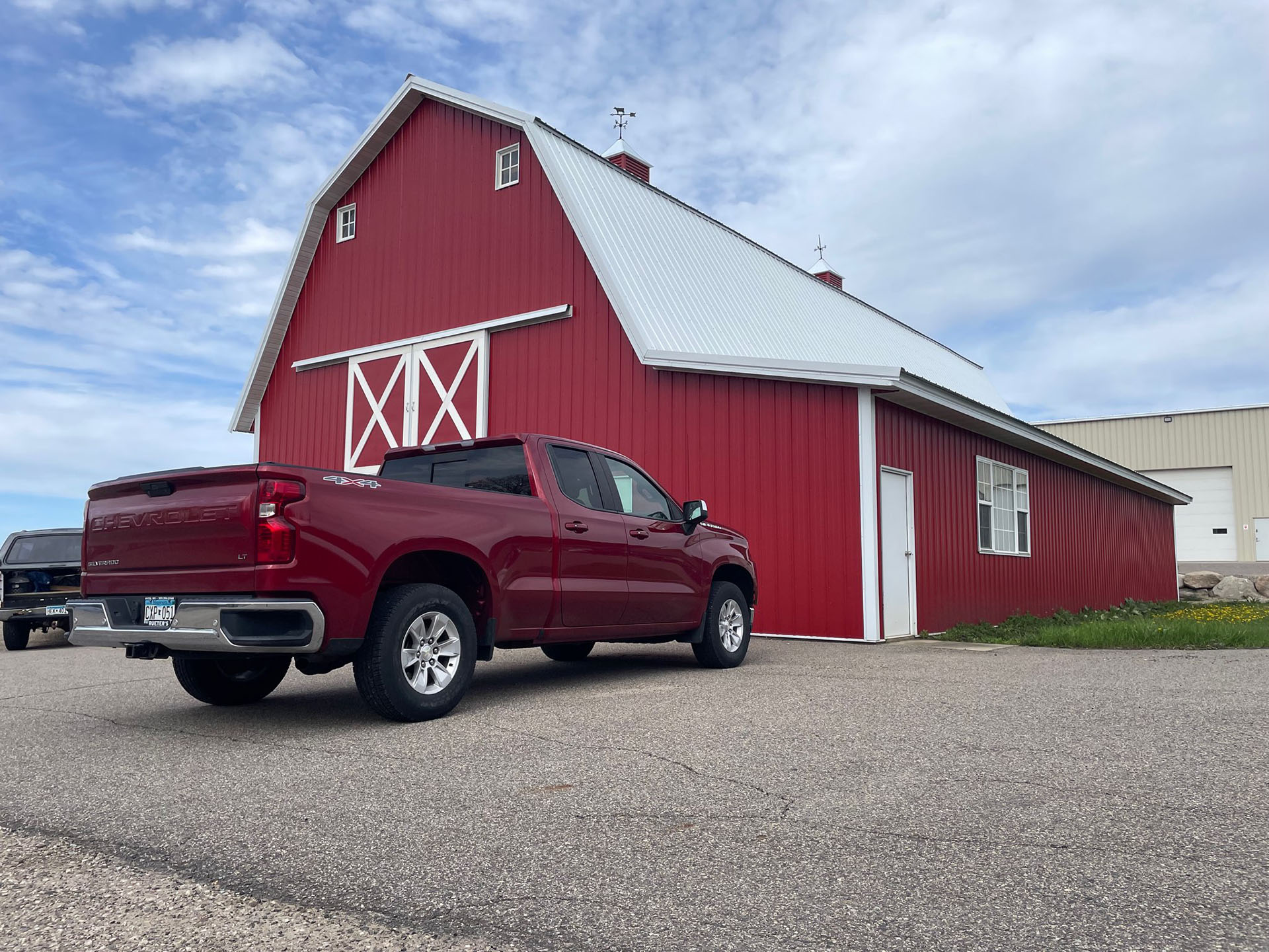 Large CAT excavator providing road maintenance in a residential area